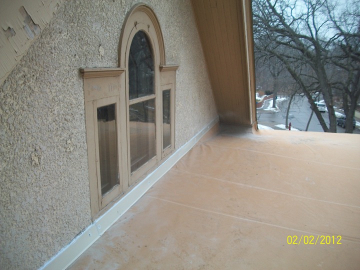 Weathered tan roofing membrane on a home