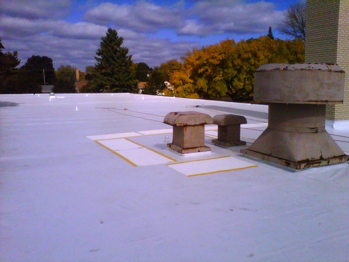 White commercial roof with vents coming through
