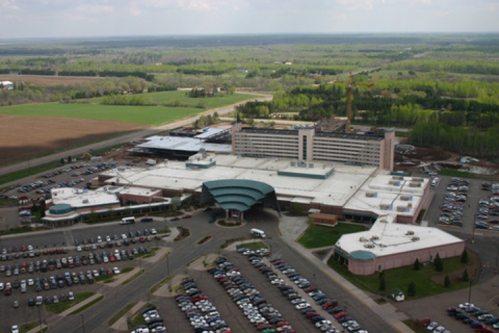 View showing a large commercial building and its parking lot