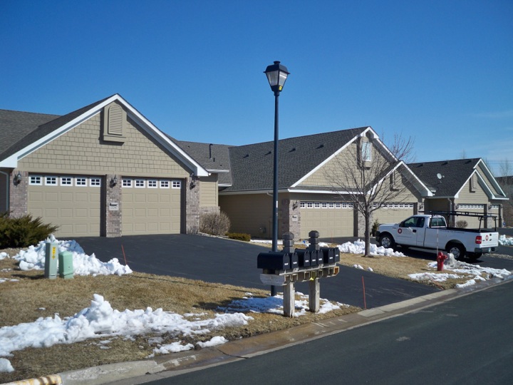 Street view showing townhomes that recently had shingle roofing replacements