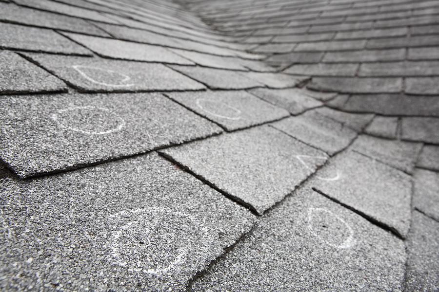 Old roof with hail damage, chalk circles mark the damage. Shallow depth of field