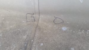 Circles drawn around commercial roofing damage from hail