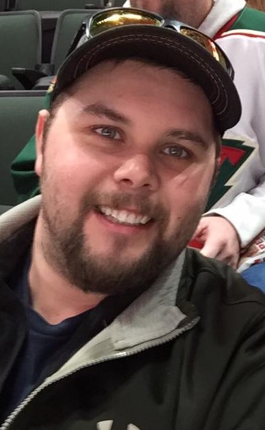 Mat Gill smiling while at a MN Wild game