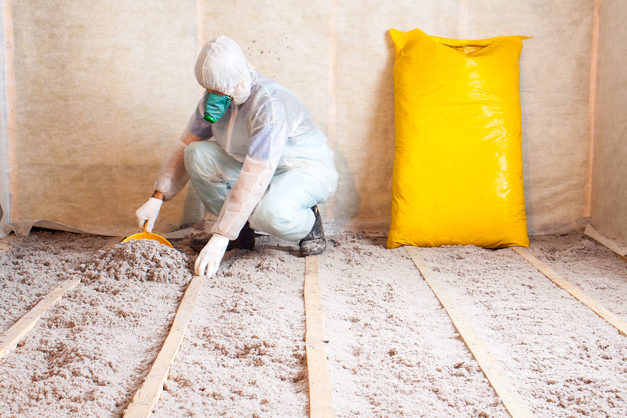 Roofer adding more roof insulation to home.