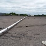 A pipe stretching across a commercial roof