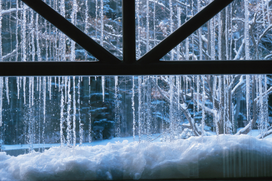 Icicles hanging in front of a window