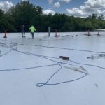 commercial roofers working on a roof
