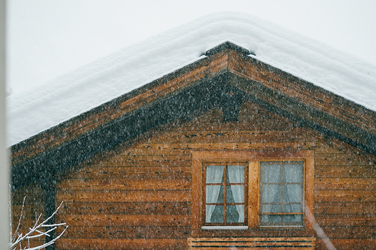 Snow hanging off roof of residential home.