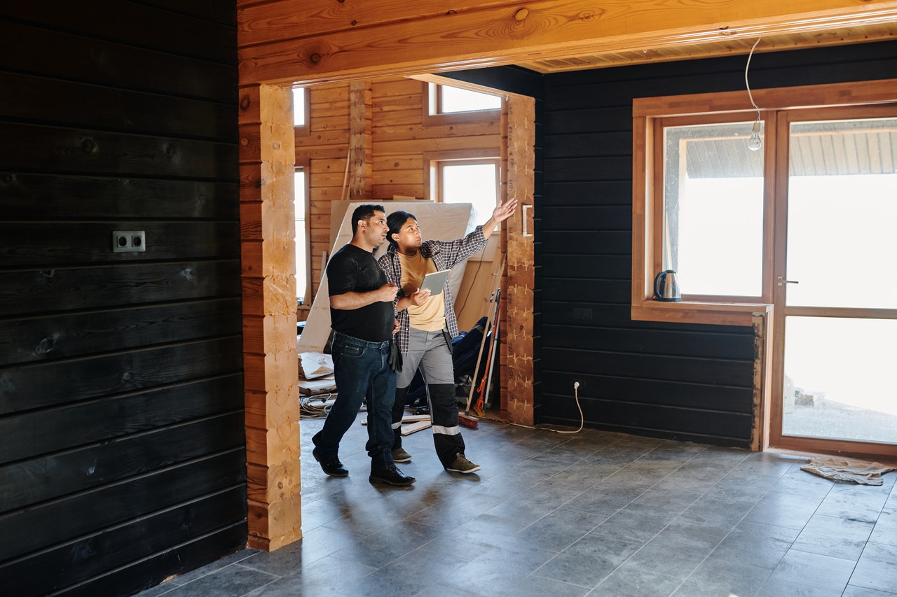 Two roofers walk through home to assess common roofing issues.