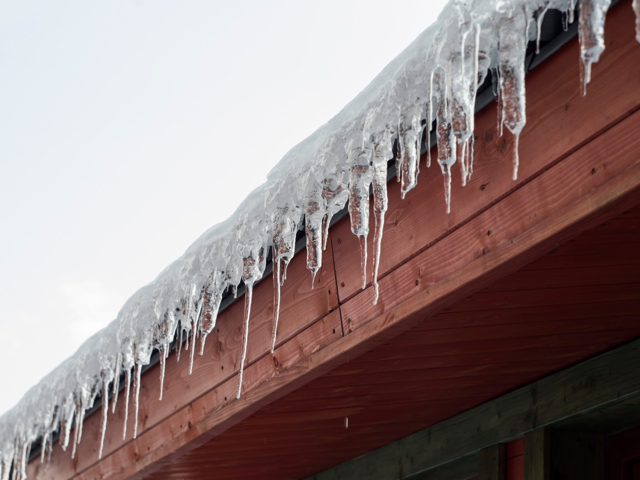 Short icicles hanging off of a roof