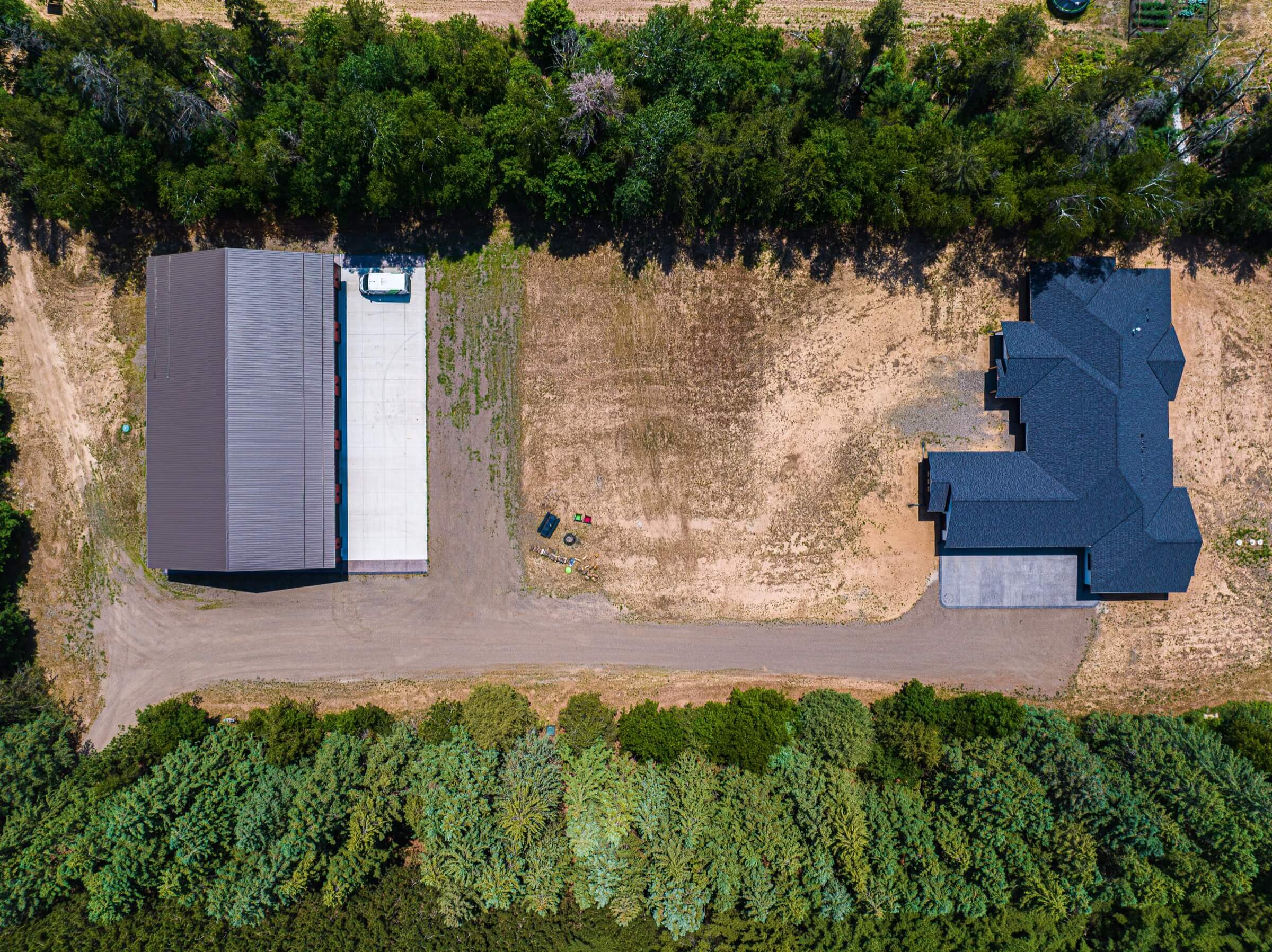 Aerial view looking over a large home and workshop
