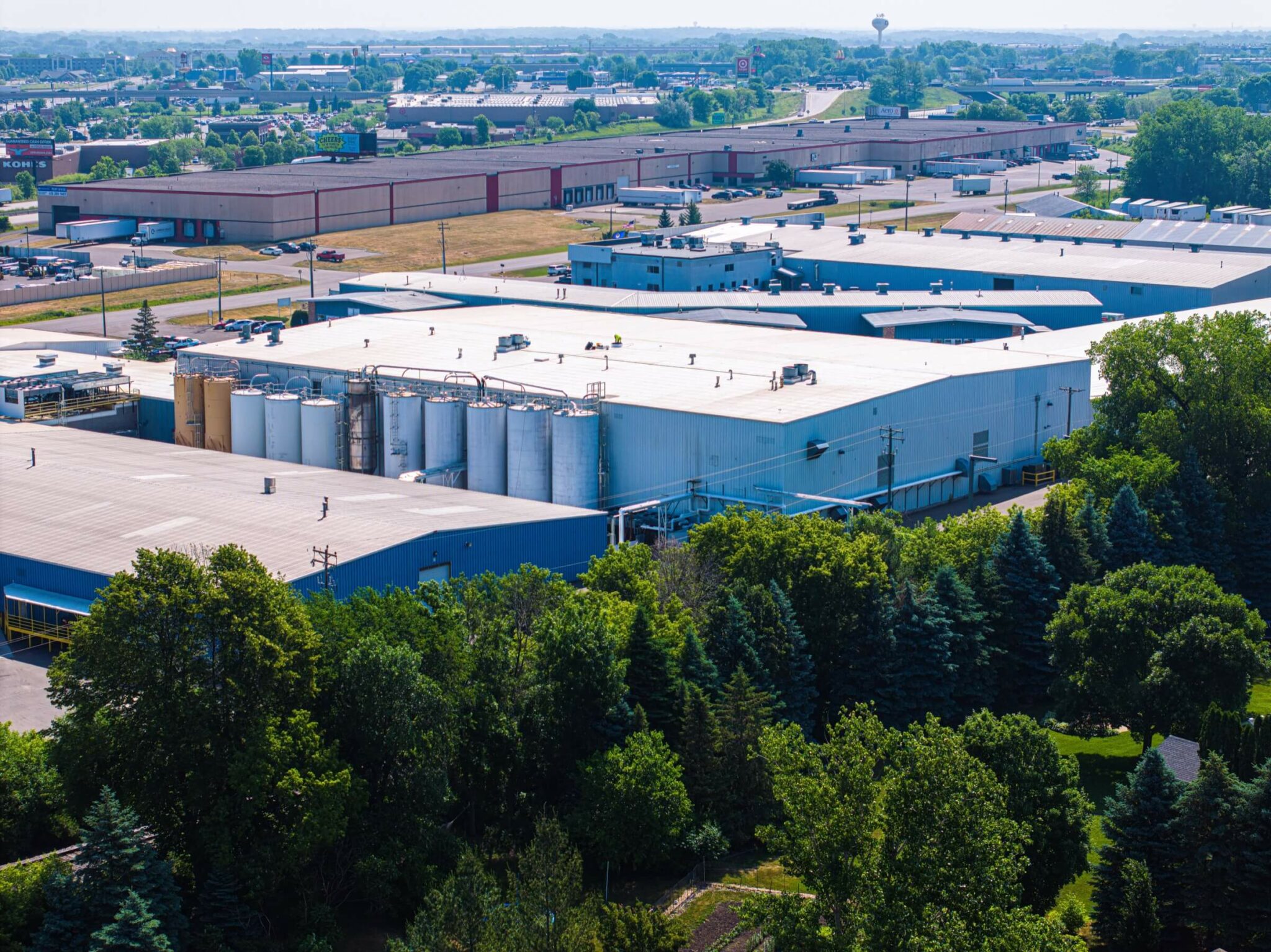 Aerial view showing a row of industrial buildings with slightly pitched roofs