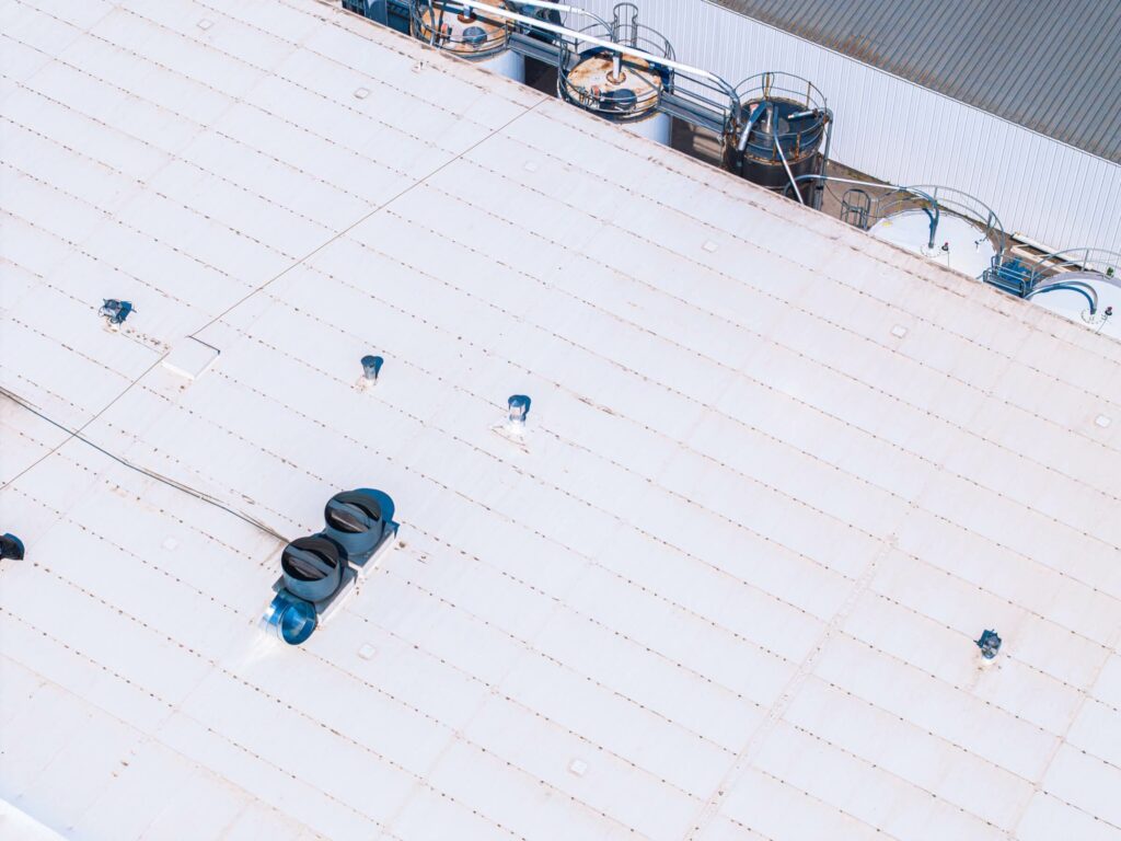 View showing white industrial roofing atop a building