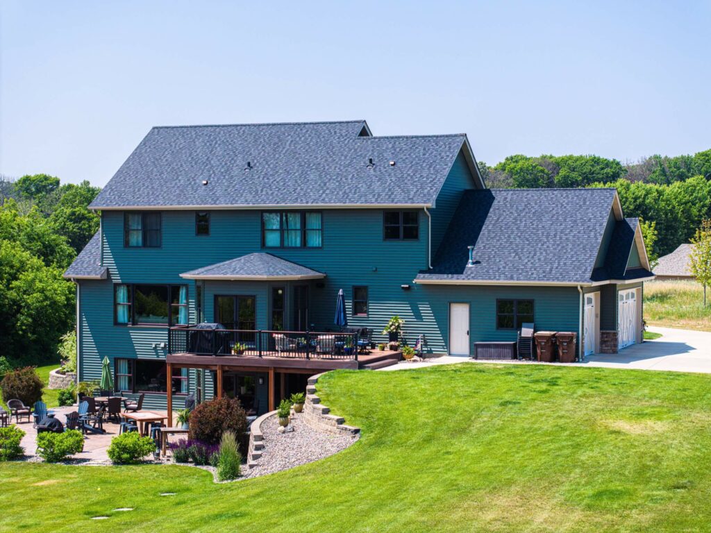 Large three-story home with asphalt roofing shingles