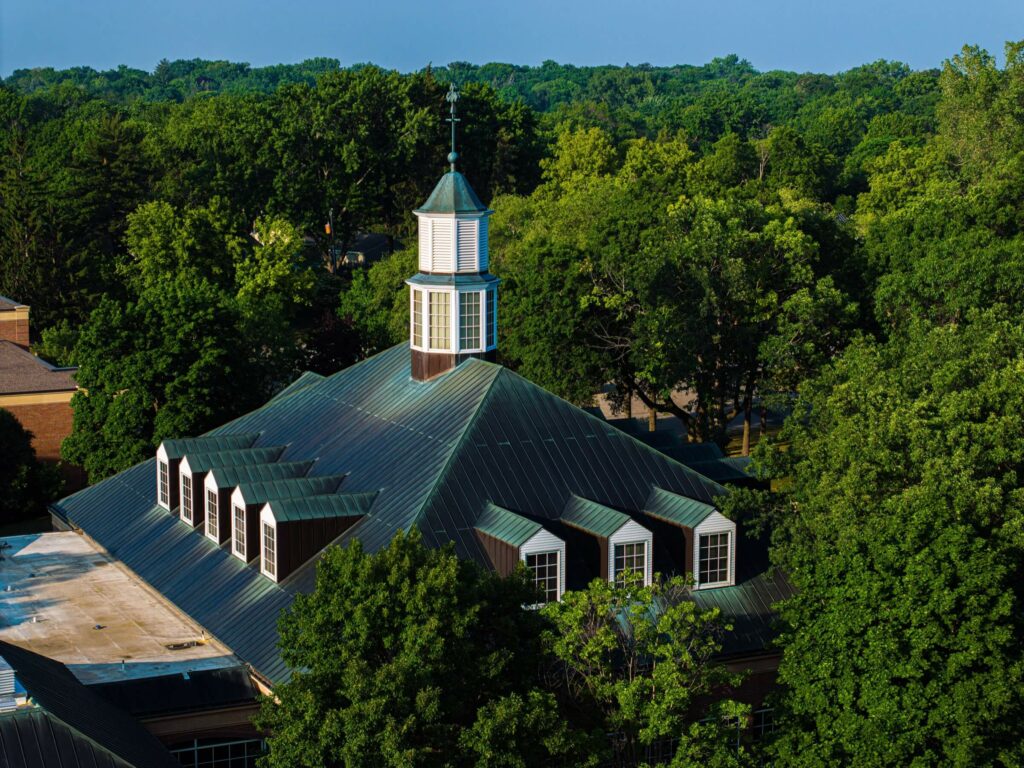 Drone shot showing the green metal rooftop of a church