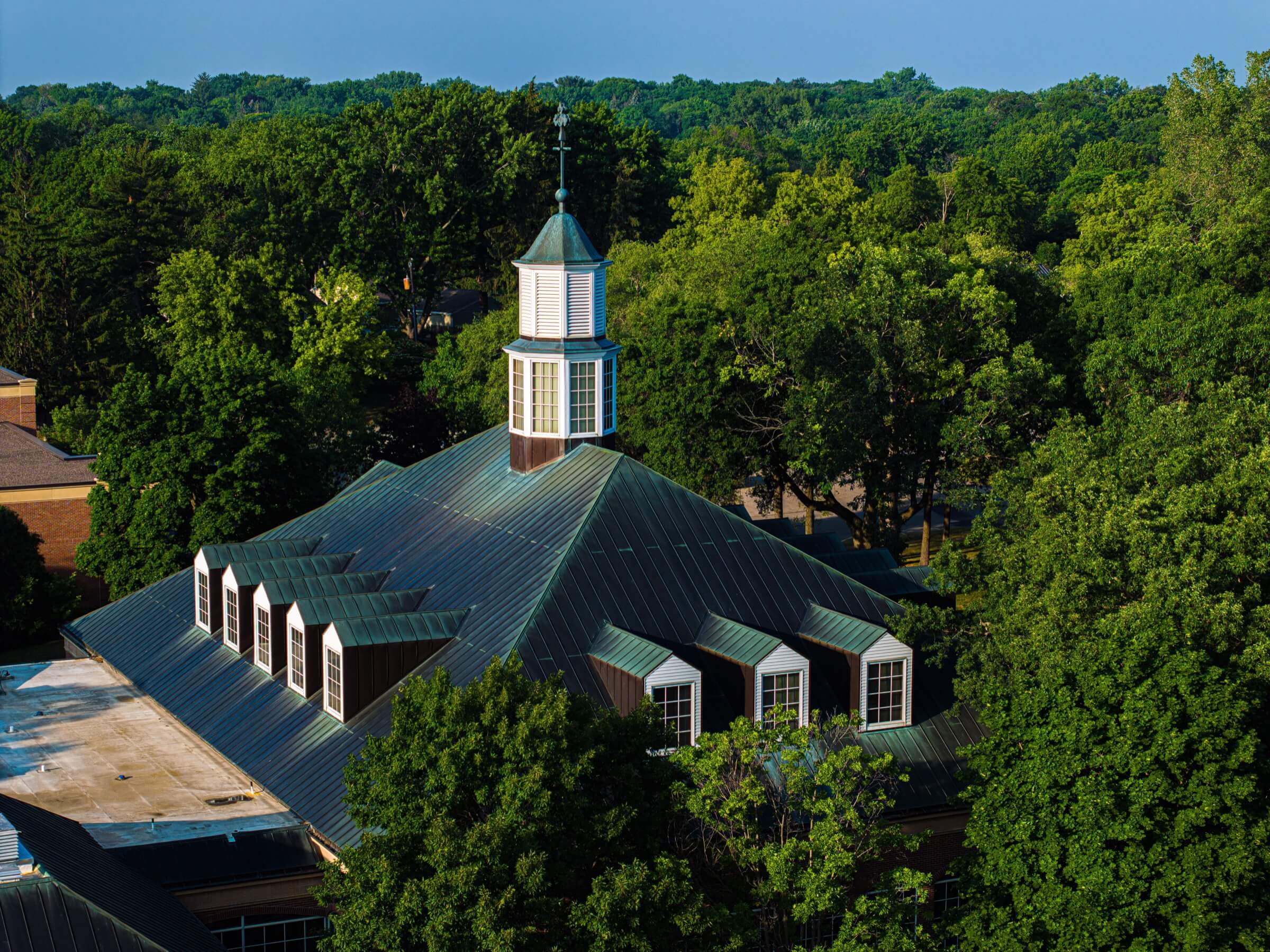 Drone shot showing the green metal rooftop of a church