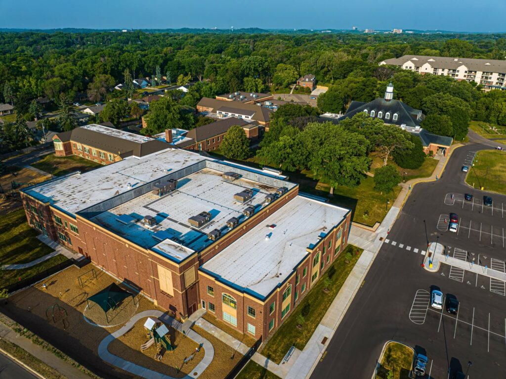 Aerial view showing the roofs of a school and church